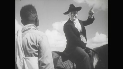 UNITED STATES: 1950s: cotton picker on plantation talks to man on horse. Stock Footage