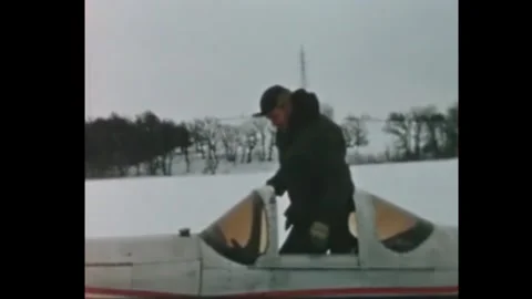 UNITED STATES - 1950s - The driver waves from the snowmobile as he drives the Stock Footage 340587033