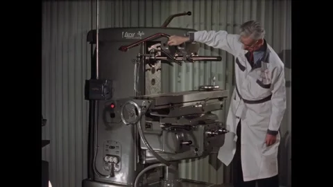 UNITED STATES - 1950s - An elderly worker operates a milling machine at a Stock Footage 340654015