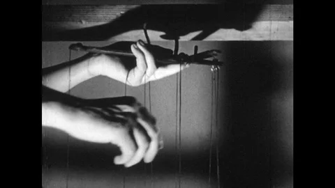 UNITED STATES 1950s: Hands Pulling the Strings of a Puppet Stock Footage 74955208