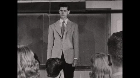 UNITED STATES 1950s: A man in a patterned jacket stands before an audience, then Stock Footage 337128310