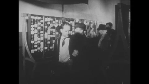 UNITED STATES 1950s: Men punch in at time clock / Workers exit factory / Workers Stock Footage