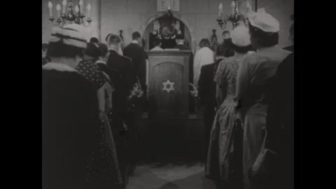 United States 1950s: People in congregation in sanctuary. Man on stage blesses Stock Footage 312292829