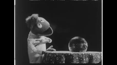 United States 1950s: Puppet talking to crystal ball, puppet appears in ball. Stock Footage 323326390