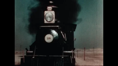 UNITED STATES 1950s: Steam engine train rolls down track. Puffs of steam from Видео 318907248