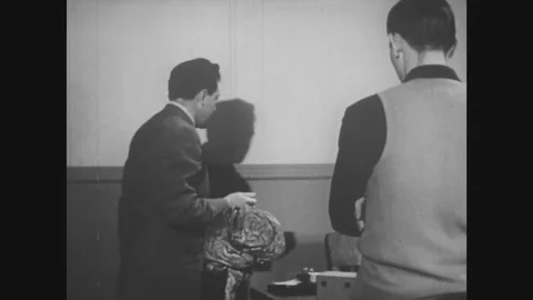 UNITED STATES: 1950s: teacher pulls down anatomy poster in classroom. Diagram of Stock Footage