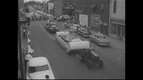 UNITED STATES: 1950s: tractor pulls float in parade. Stock Footage 75360027