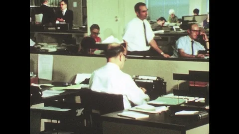 UNITED STATES: 1950s: workers in office. Train cars prepare for transportation Stock Footage