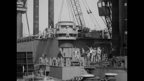 UNITED STATES - 1955 - Crewmen pulling rope as the mobile crane lowers the Stock Footage 322761834
