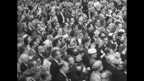 United States 1960: A large crowd gathers outdoors, watching and applauding an Stock Footage 74923306