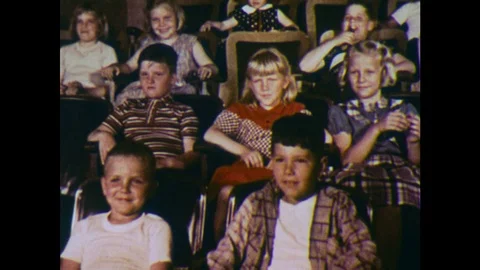 UNITED STATES 1960s: Children laugh while watching a movie. Stock Footage