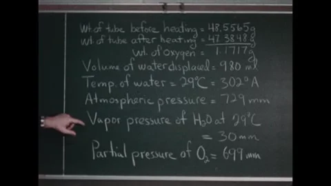 UNITED STATES 1960s: Hand points to a series of experiment data on a chalkboard: 스톡 동영상 321701488