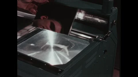 United States 1960s: Hands remove plastic moel from projector screen. Hands Stock Footage 322142487