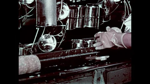 United States 1960s: Inside pineapple canning factory, machines in rows, people Stock Footage 335596131