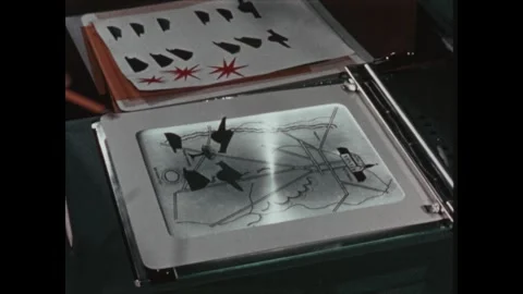 United States 1960s: Man using overhead projector, setting paper shapes on Stock Footage 322142385