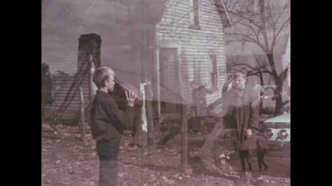 United States 1960s:A rustic log cabin stands in a rural landscape with bare Stock Footage 336802402