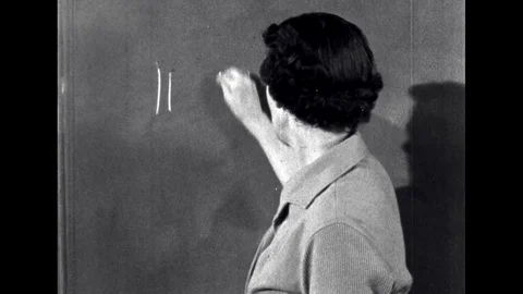 UNITED STATES 1960s: Teacher Draws Lines on Board with Chalk Stock Footage