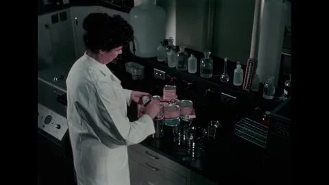 UNITED STATES - 1964 - A technician opens a can containing meat abroad to test Stock Footage 340658208