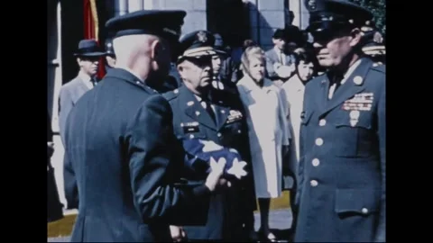 UNITED STATES - 1965: Flag presentation - An officer holds a folded flag Stock Footage 344907560