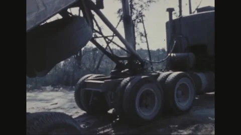 UNITED STATES - 1969: Loader arm lifts debris, broken trees Stock Footage 341813451