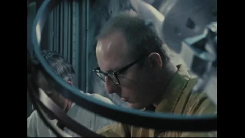 UNITED STATES - 1970: Analyst at work behind a gimballed model Видео 341851297
