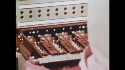 UNITED STATES 1970s: Control panel, hand turns knobs / Tracking shot through Video stock 75191845