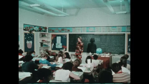 United States 1970s: Dead fish on shore. Teacher talking to kids in classroom, Stock Footage 346475729