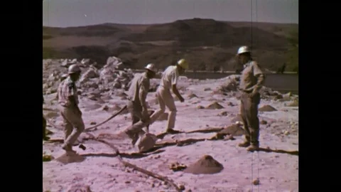 UNITED STATES: 1970S: engineers install gel at blast sites. Explosives pumped Stock Footage 75168204