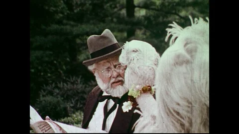 UNITED STATES 1970s: Grumpy Old Man Talks to Puppets in Park Video stock 74976256