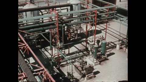 United States 1970s: High angle pan of factory. Water flowing from pipe. Tilt Stock Footage 346475911