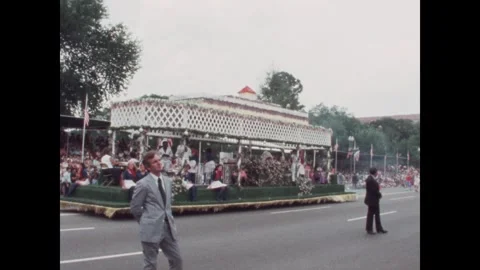 United States 1970s: Parade float with singer and dancers under gazebo. Singers Stock Footage 323326332