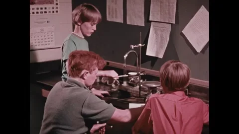 UNITED STATES - 1972 - A young man adjusts a mechanical laboratory scale used to Stock Footage 341971153