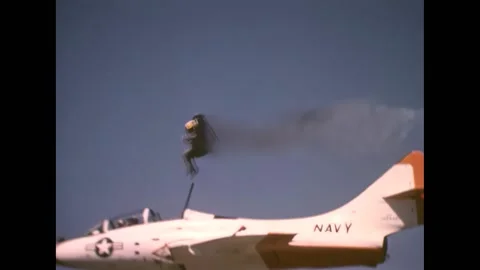 UNITED STATES - 1974 - A pilot ejects from a flying fighter, opens his Stock Footage 308103826