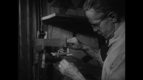 UNITED STATES: Man attaches strings to marionette. Stock Footage 75249122