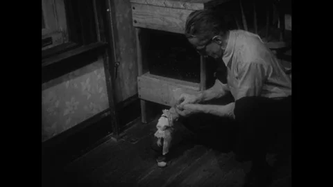 UNITED STATES: Man attaches strings to puppet's head. Stock Footage 75249144