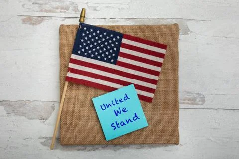 United we stand on note card with an American flag Stock Photos