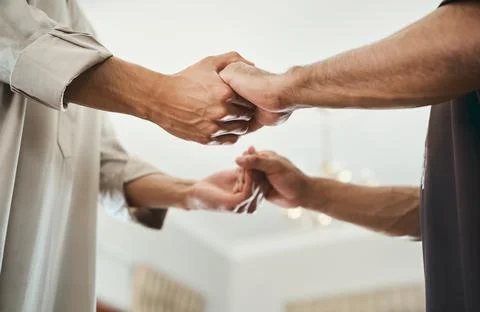 Unity, holding hands and muslim men in home, religion and respect for festi.. Stock Photos