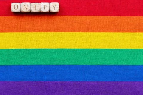 Unity message on rainbow flag background celebrating diversity and inclusion Stock Photos