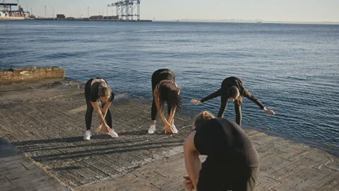 Unity with nature. Professional yoga instructor showing breathing exercise to Video stock 155415882