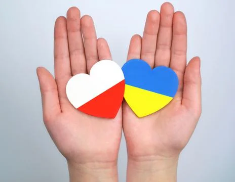 Unity solidarity help concept. Two hearts with flags of poland and ukraine in Stock Photos