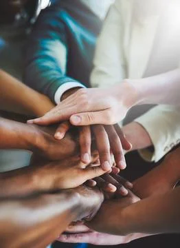 Unity is strength. Cropped shot of a group of businesspeople piling their hands Stock Photos