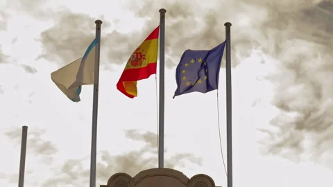 Unity Under Brooding Skies: Flags of Galicia, Spain, and the European Union Stock Footage 261872534