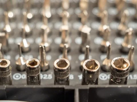 Universal set of screwdriver bits with different bits. Stock Photos