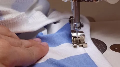 Universal sewing machine close-up with a foot for finishing stitches with a Stock Footage 318247819