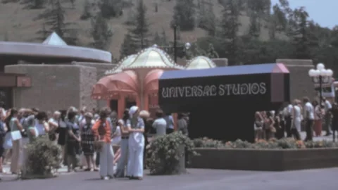 Universal Studios - 1973: group of tourist wait in queue by popular theme park Stock Footage 219787395