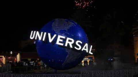 Universal Studios globe illuminated at night with colorful New Years fireworks Stock Photos
