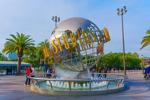 Universal Studios Globe Surrounded by Palm Trees and Visitors 스톡 사진