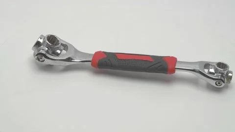 A universal wrench for nuts rotates on a white background. 動画素材 267000477