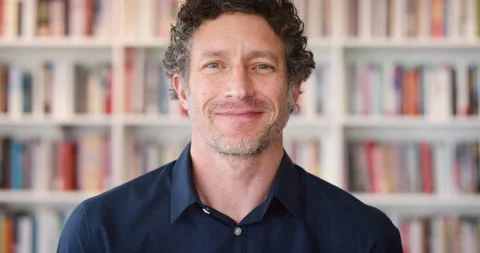 University, lecturer or man in library with face, experience or pride in Stock Footage 334538605