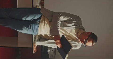 University Library: Talented Hispanic Boy Wearing Glasses Standing Reads Book Stock-Footage 260113485